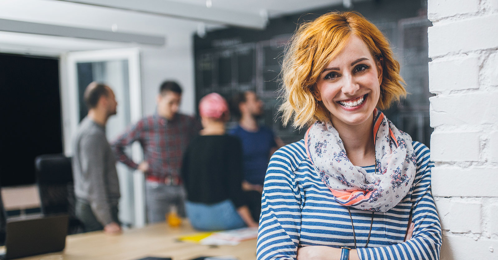 Woman in a conference room working on business degree online