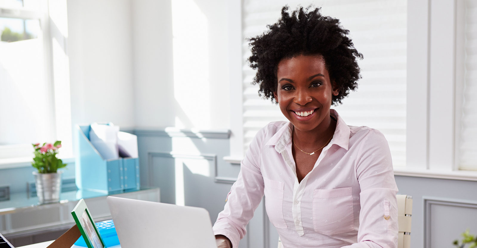 Woman using a laptop sitting at a desk