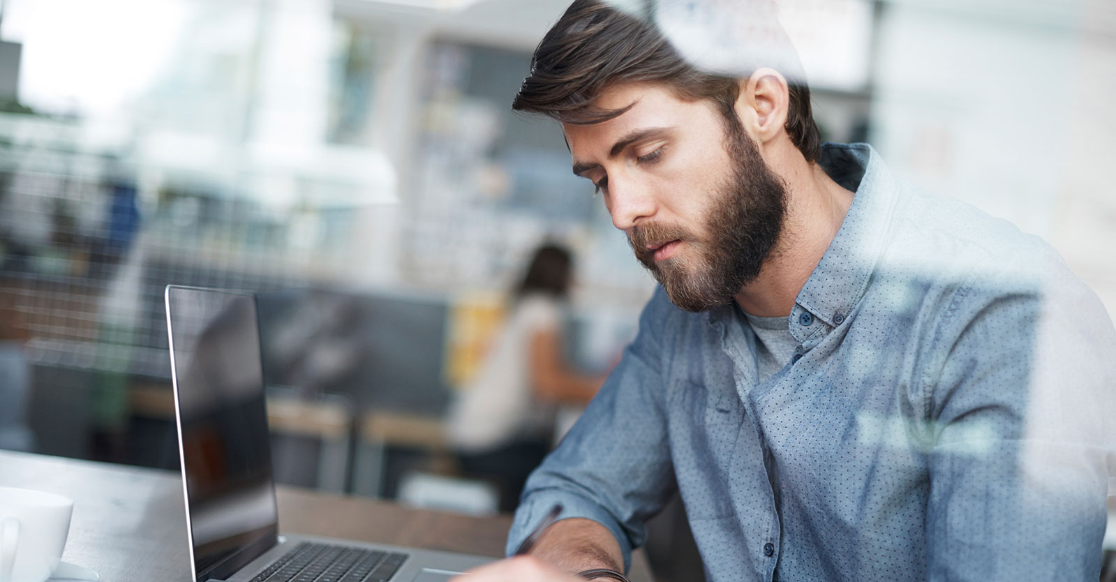 Man writing notes on a notepad