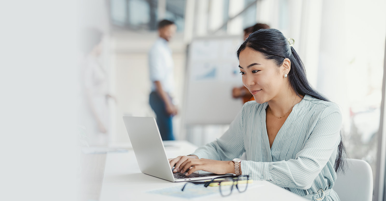 Woman sitting at a desk using a laptop