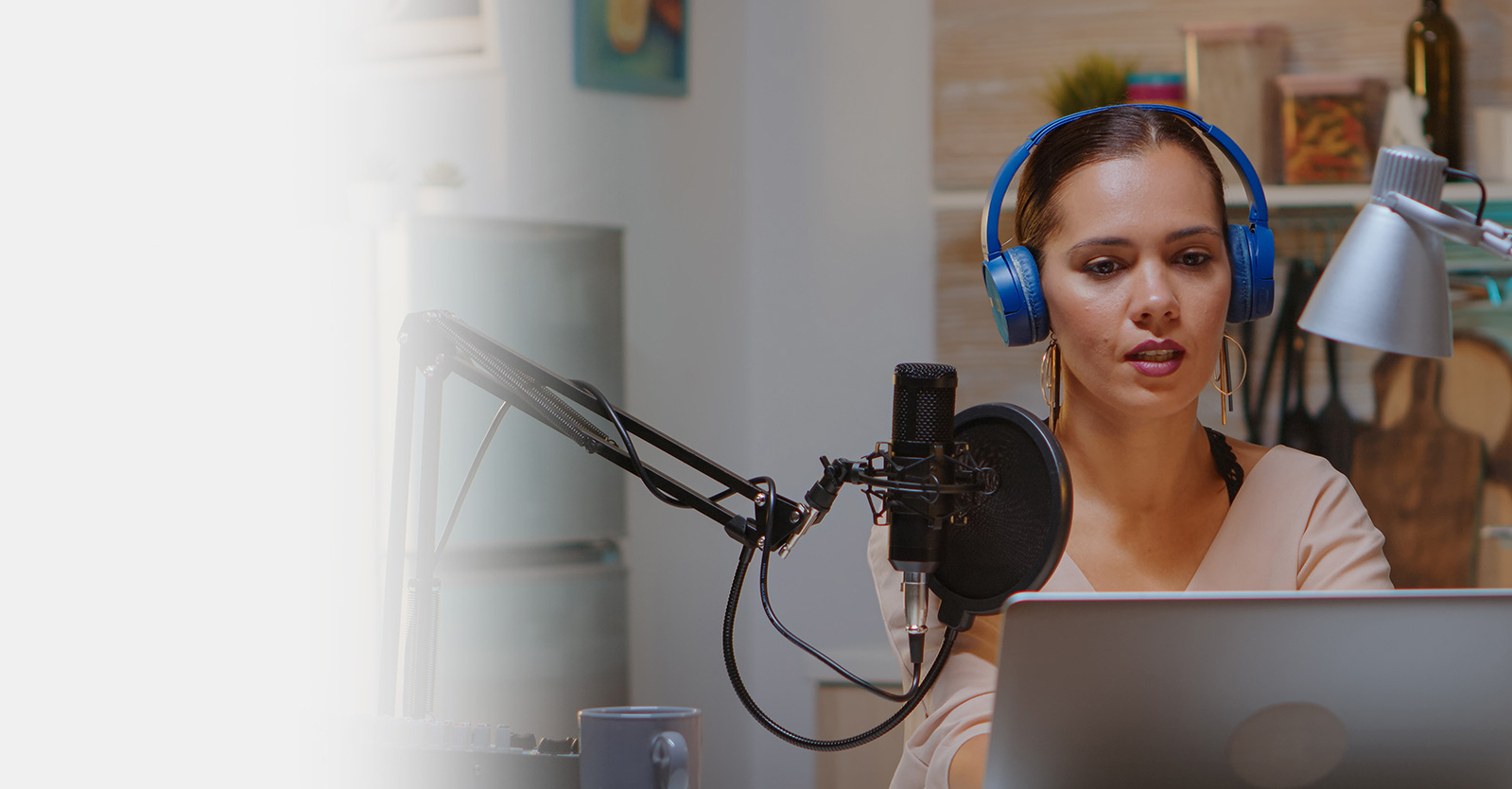 Woman using a laptop wearing headphones
