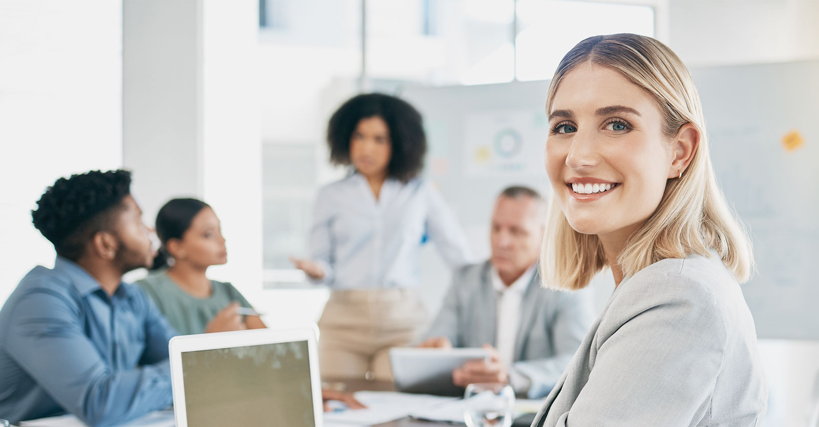 Woman attending a meeting using a laptop