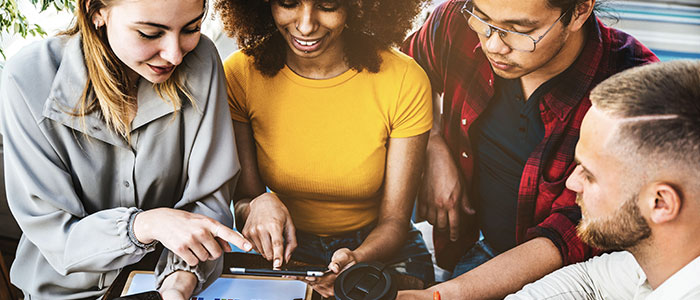 Group of people using a tablet