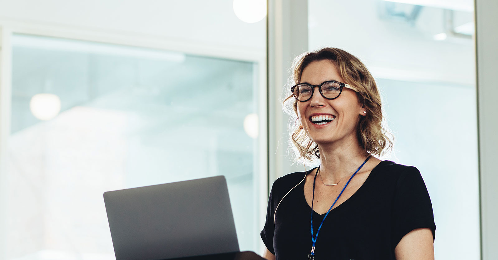 Smiling woman using a laptop