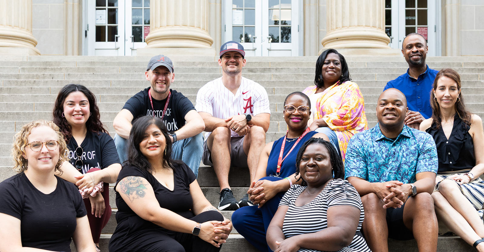 A group of students sitting on steps outside a building