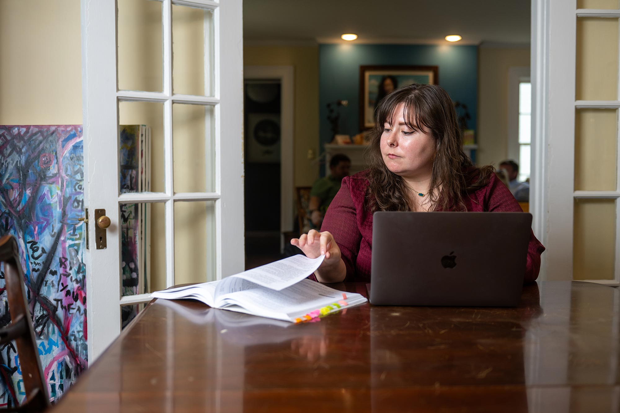 Woman sitting at a table reading notes