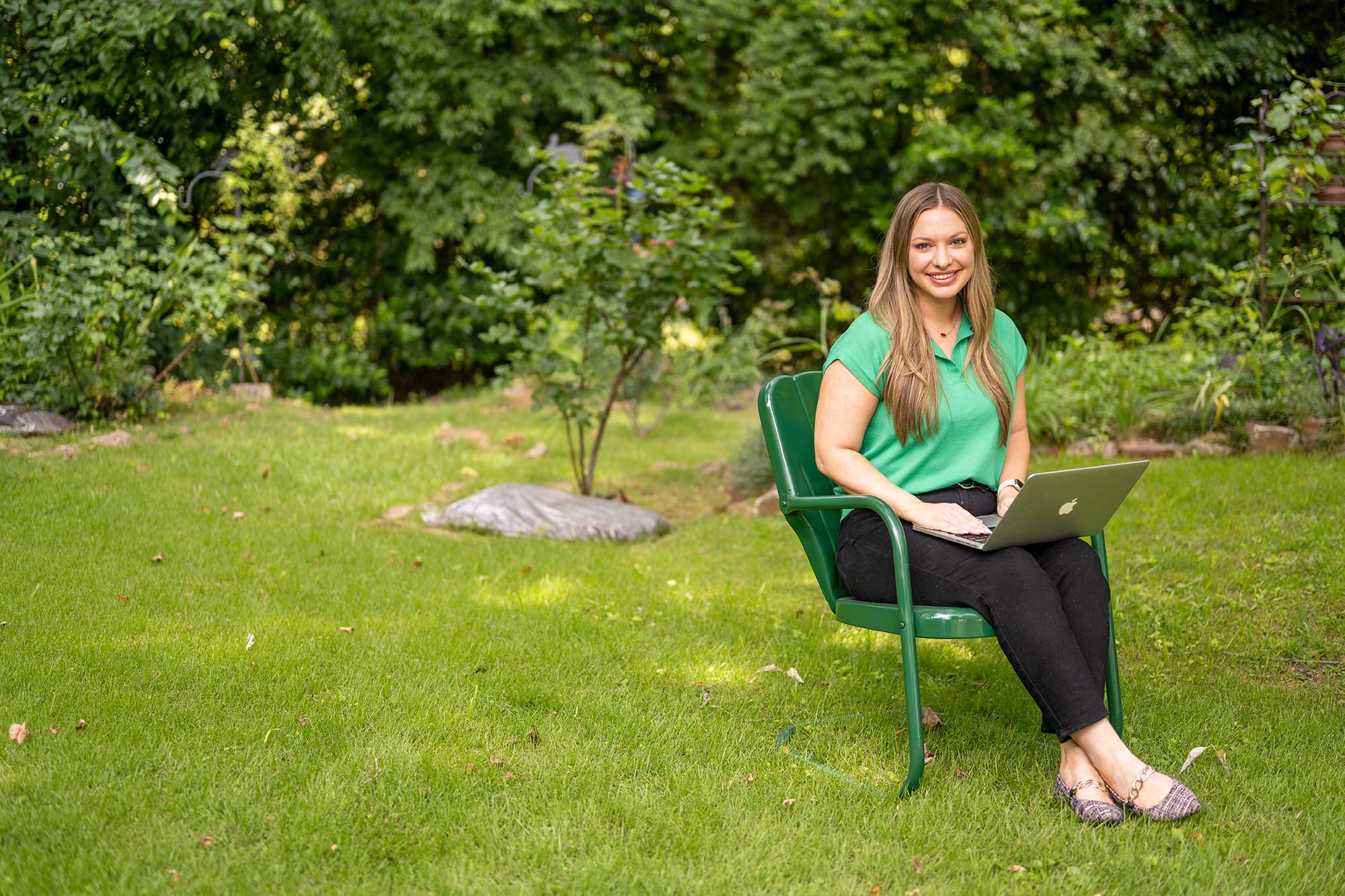 Woman sitting outside with a laptop