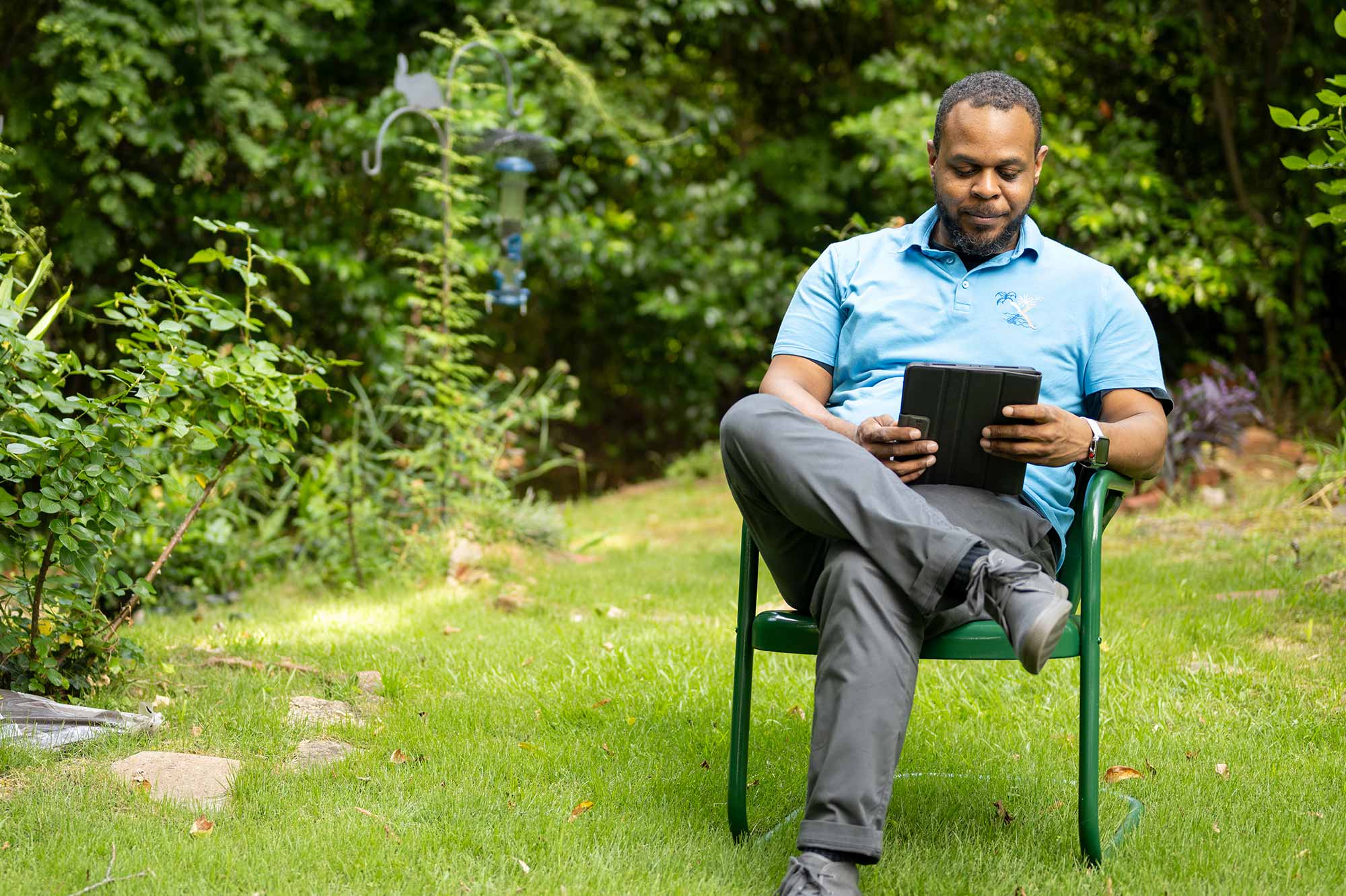Man sitting outside using a tablet