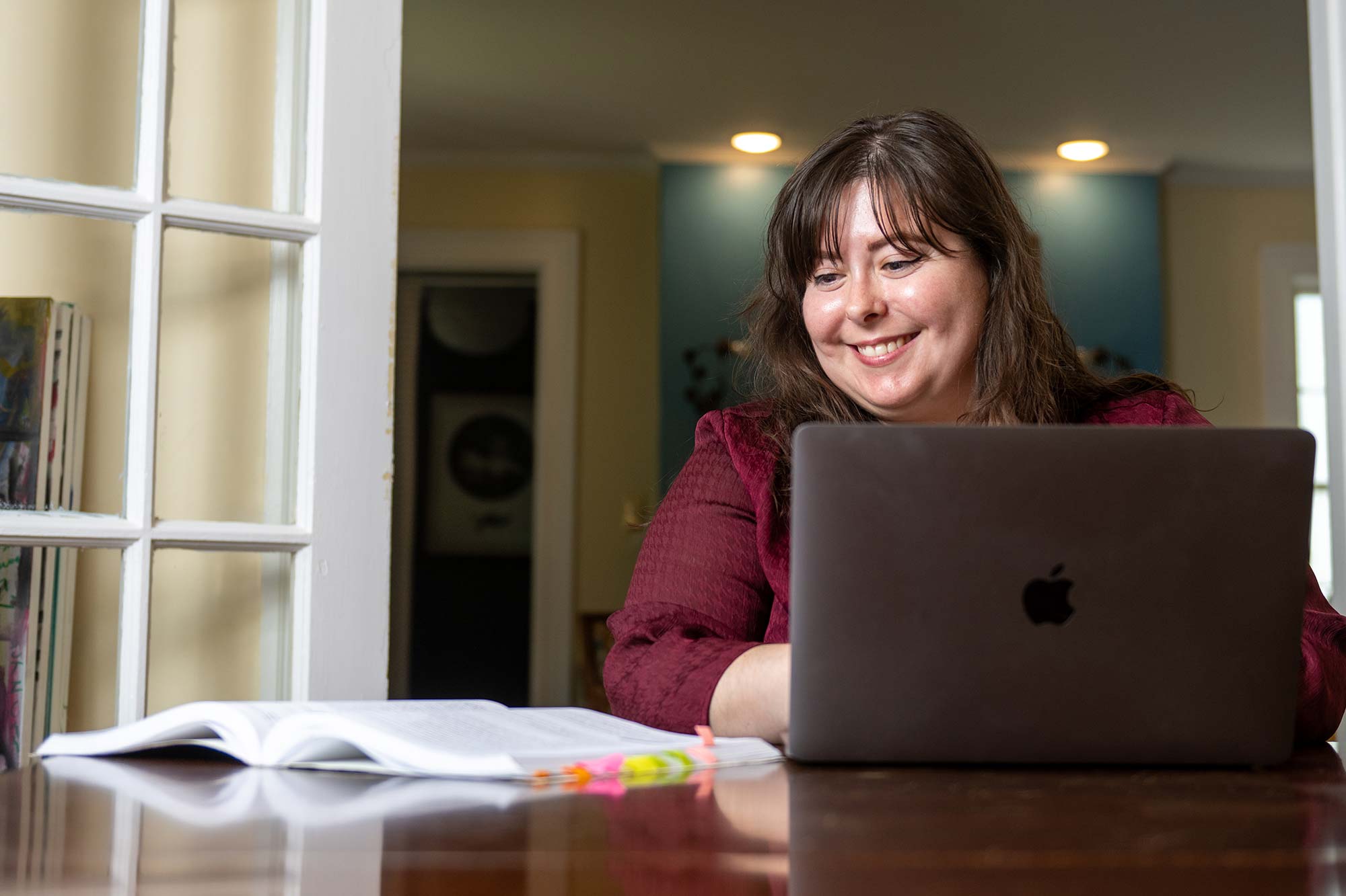 Woman using a laptop sitting at a table