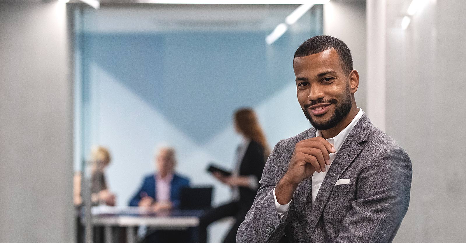 Man standing outside of a conference room