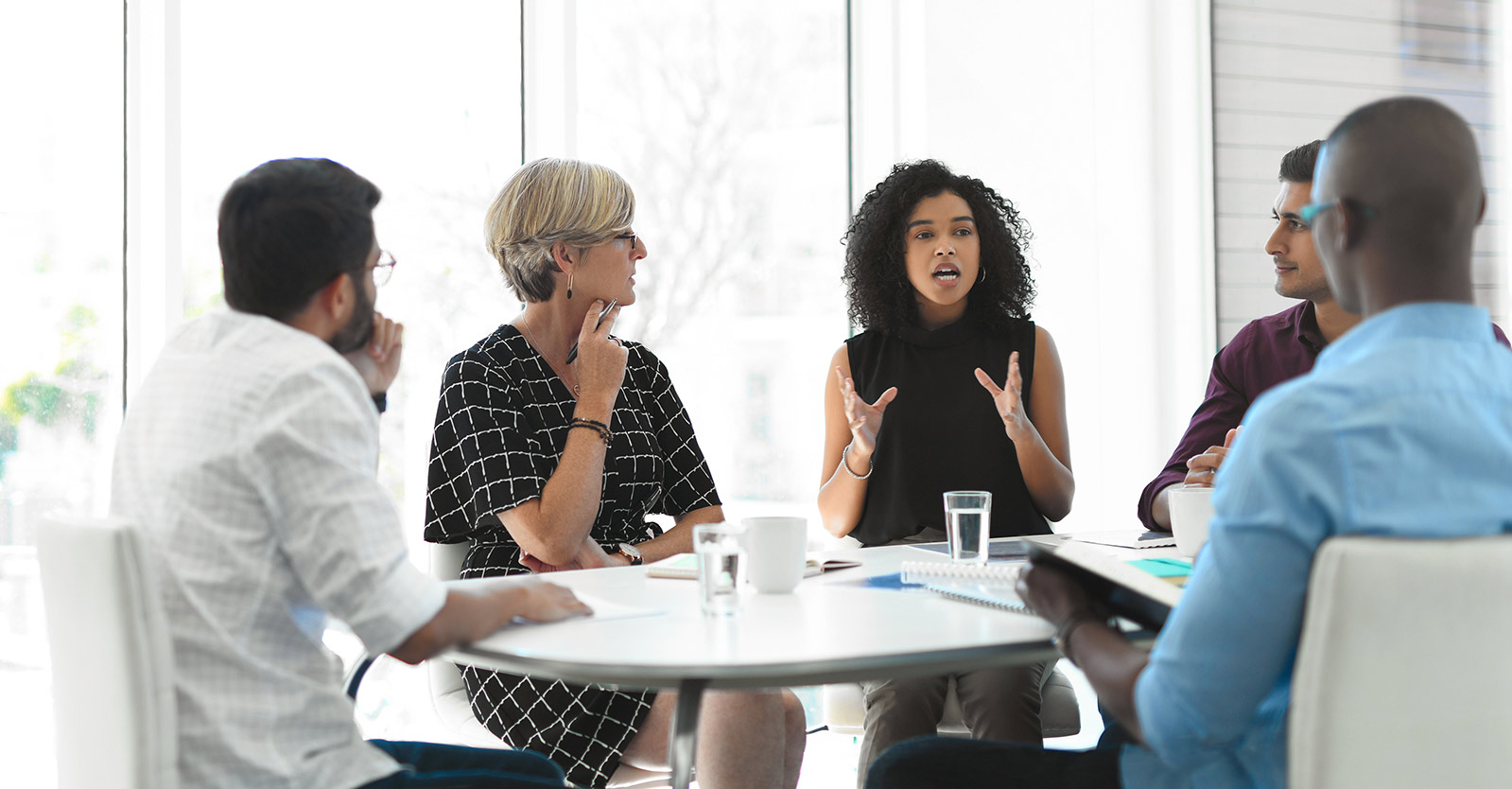People in a meeting sitting at a conference table
